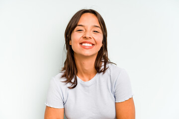 Young hispanic woman isolated on blue background laughing happy, carefree, natural emotion.