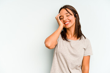 Young hispanic woman isolated on blue background funny and friendly sticking out tongue.