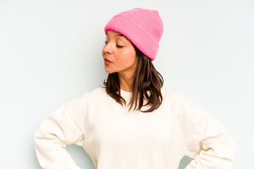 Young hispanic woman isolated on blue background holding and showing a product on hand.