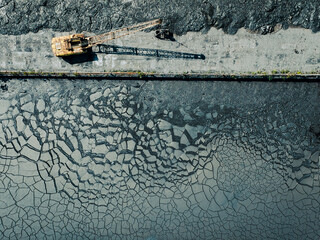 Black Coal Mine. Abandoned Heavy Equipment. Ecology Disaster.