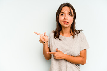 Young hispanic woman isolated on blue background showing a copy space on a palm and holding another...