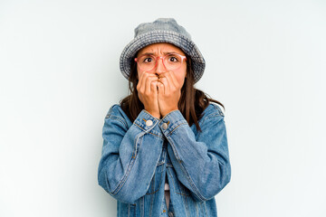 Young hispanic woman isolated on blue background winks an eye and holds an okay gesture with hand.