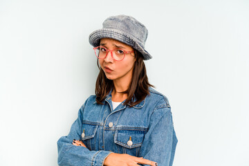 Young hispanic woman isolated on blue background smiles, pointing fingers at mouth.