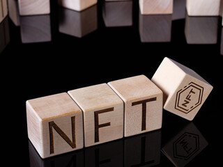 Text NFT on wooden cubes as concept of non-fungible tokens trading