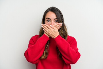 Young caucasian woman isolated on white background shocked covering mouth with hands.