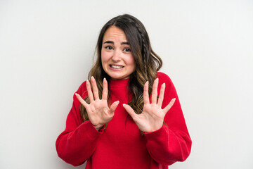 Young caucasian woman isolated on white background rejecting someone showing a gesture of disgust.