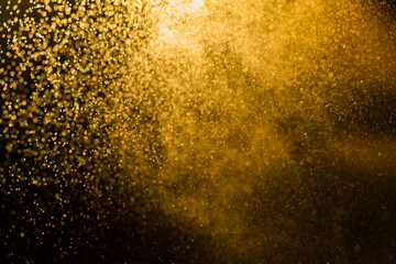 Fototapeta na wymiar Dark golden bokeh glitter texture background