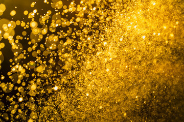 Dark golden bokeh glitter texture background