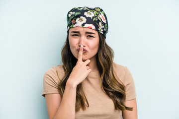 Young caucasian woman isolated on blue background thinking and looking up, being reflective, contemplating, having a fantasy.