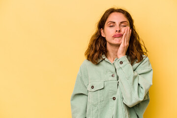 Young caucasian woman isolated on yellow background who feels sad and pensive, looking at copy space.