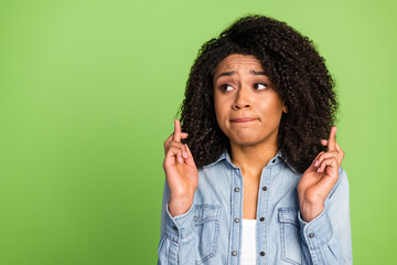 Photo of young girl worried nervous look empty space devotion pleading wish isolated over green color background