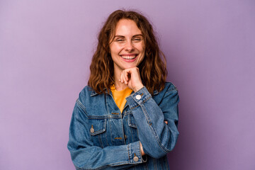 Young caucasian woman isolated on purple background smiling happy and confident, touching chin with hand.