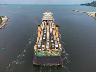 car ferry boat transports trucks in the sea, aerial view
