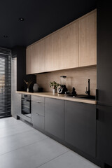 Modern black kitchen with wooden details