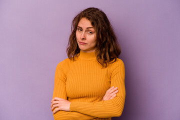 Young caucasian woman isolated on purple background unhappy looking in camera with sarcastic...
