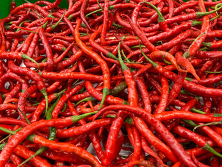 pile of fresh red chili peppers in the market. cabai merah or cabe merah, one of very popular ingredients in Indonesia.