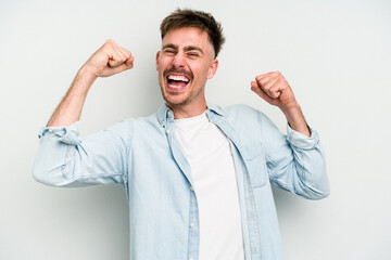 Young caucasian man isolated on white background cheering carefree and excited. Victory concept.