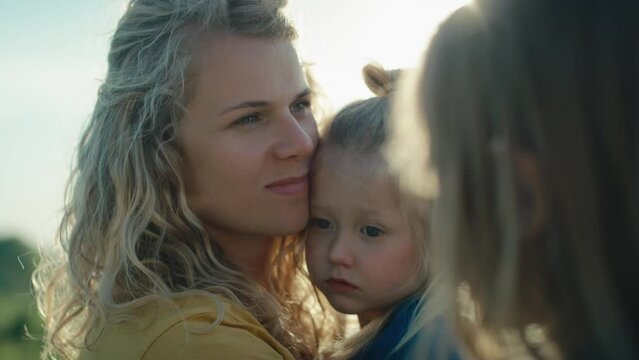 Close up of mom with two daughters spending time at the meadow. Shot with RED helium camera in 4K.     