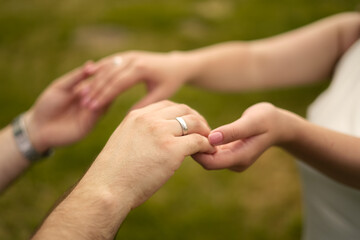 bride and groom hold hands. Large frame. You can see the wedding rings