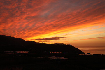 Red sunset on the mountains with a sea view