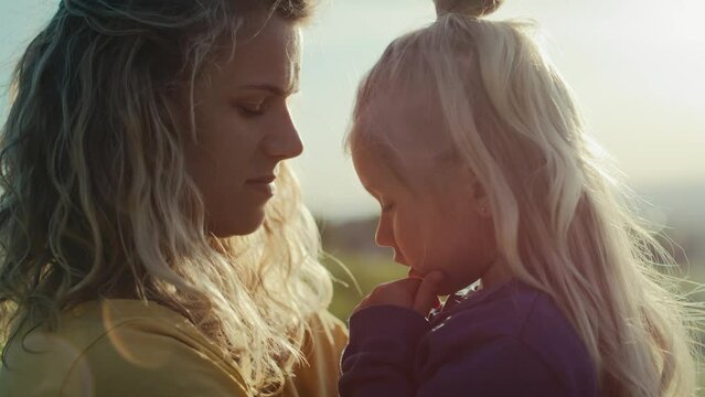 Mom with little daughter bonding and spending time together at the meadow. Shot with RED helium camera in 4K.    