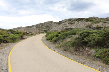 Curvy Road with yellow lines going up the mountains in Spain