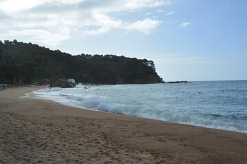 rought morning sea on the beach of Cala Canyelles