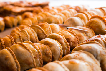 freshly baked empanadas with different fillings for sale