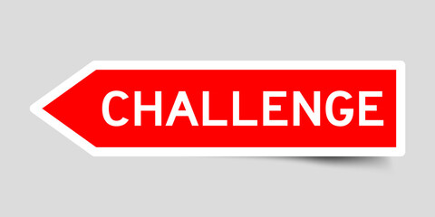 Red color arrow shape sticker label with word challenge on gray background