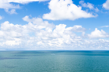 Fototapeta na wymiar Beautiful calm turquoise color sea and blue sky with white color cloud background