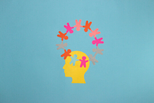 yellow paper head on it circle of paper people, creative modern design on pastel blue background, population day, the importance of all people in this world