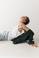 Portrait of young man, teen, student posing isolated over white studio background. Concept of fashion, youth, emotions, facial expression, ad