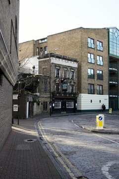 Vertical Shot Of An Empty Brick Street With Buildings In East London