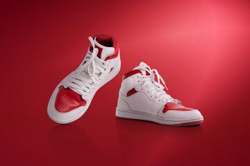 Strolling sports shoes on red background. Sneakers or trainers isolated. Athletic shoes. fitness, sport, training concept. Urban fashion