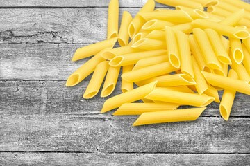 Penne pasta. Raw italian pasta on background,