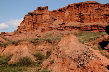 Fototapeta premium Landscape with red mountains Narman Peribacalari, formed due to erosion and weathering, against the blue sky with clouds, near the city of Erzurum, in the region of Eastern Anatolia, Turkey