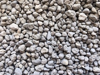 Stock photo of fine grained stone. Clay zeolite chips, bulk coating, drainage, filler, crushed stone. Macro photography of natural dusty gray stone for background, print, design, texture