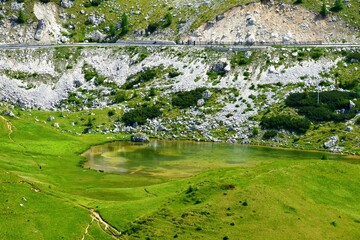 View of Valparola lake bellow the road across themountain pass in Dolomite Mountains Veneto region,...