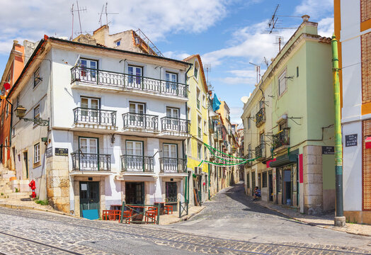 Crossing the streets of Rua do Salvador and Rua das Escolas Gerais. Lisbon, Portugal