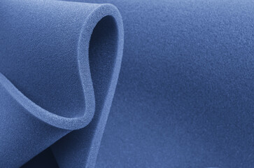 Foam sponge rolled up.
blue foam folding sponge. rubber texture sheet with wavy edges