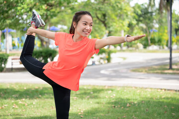 Asia teenager woman training yoga at garden	