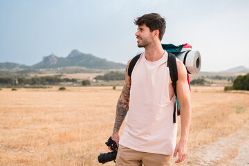 Man with hiking backpack and camera outdoors
