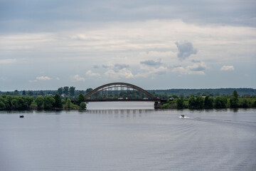 large metal railway bridge across the river against the blue sky