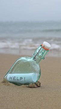 Bottle on beach with message on paper inside