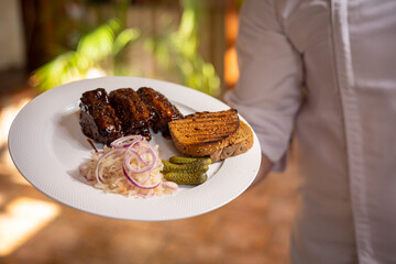 Food. Grilled Meat And Vegetables With Sauce Closeup. Grilles Pork Ribs In Restaurant.