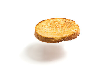 A floating slice of fried bread on a white background. Round flying toast. Isolated