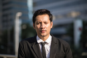 Naklejka premium Asian Businessman Outdoors