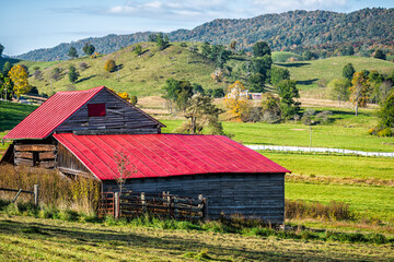 Rural countryside farmhouse house, rustic home building on farm by rolling hills at autumn...