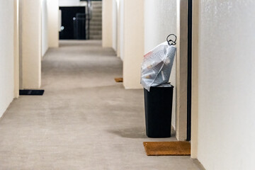 Concierge valet door to door trash collection services for apartment with garbage in bin and...