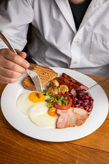 English breakfast on a wooden table in a restaurant
